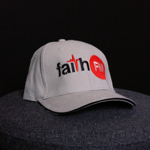 A grey-brown cap with the Faith FM logo embroidered on the front.